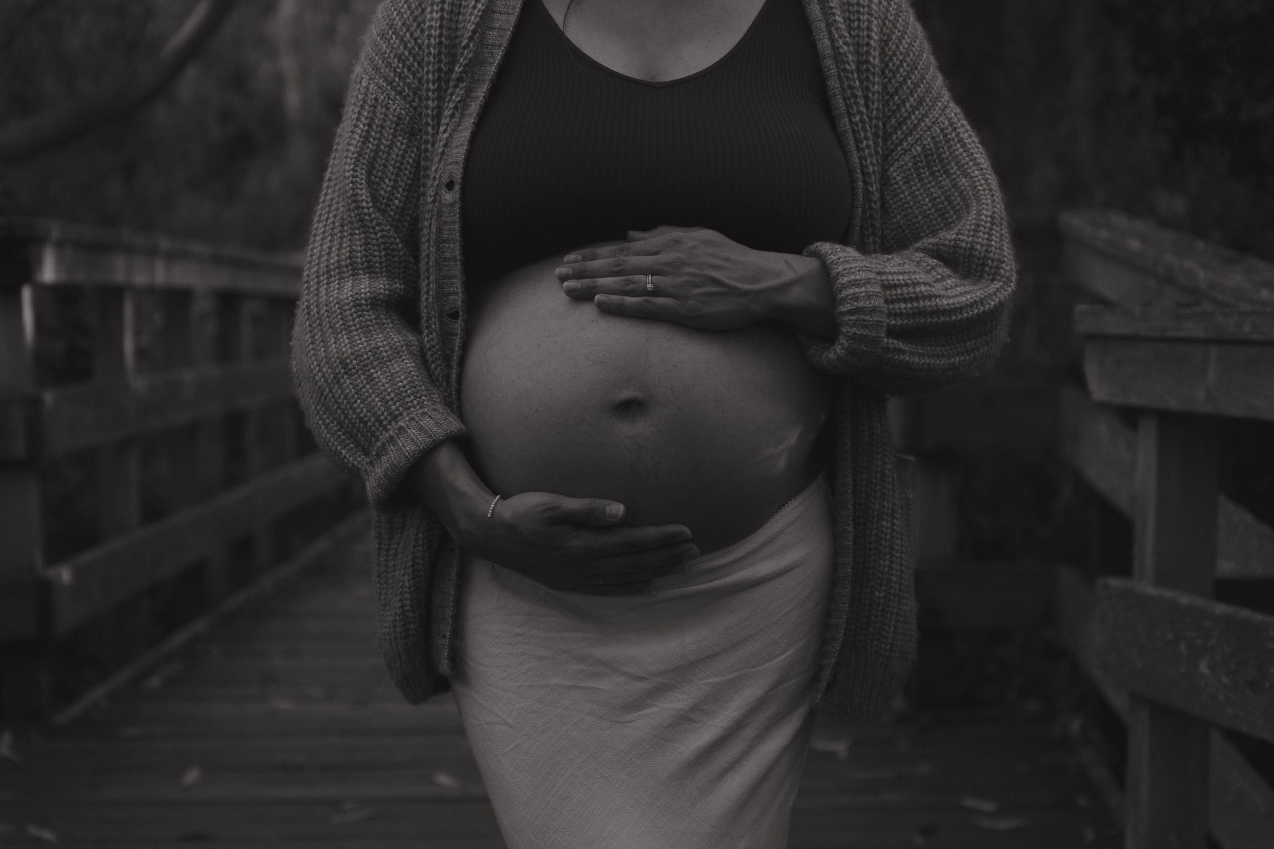 A mother holding her belly on the Santa Cruz boardwalk